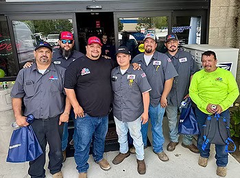 Group of Fresno Heating and Cooling employees standing in front of a building
